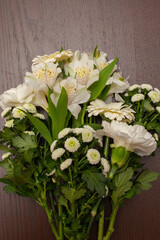 lush summer bouquet or arrangement of white flowers, leaves and berries against a dark background, wild rose, carnations, jasmine, clematis, Oregon grape, floral design element for cards or packaging
