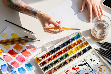 Female Artist Starting To Draw On Blank Sheet Of Paper.
