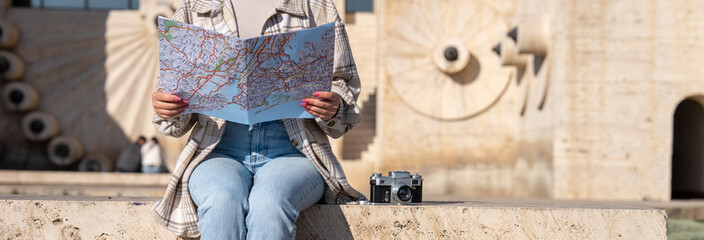 Navigating New Horizons: A Tourist Orients Himself with a Map in the City