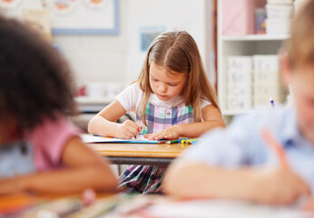 Little girl, preschool and coloring with book in class for creative activity, learning or education. Child, kid or kindergarten student with pencil crayon for youth development or fine motor skills
