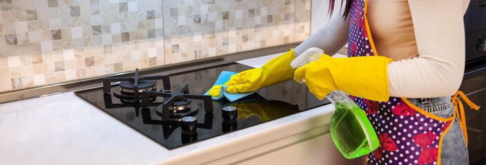 Housewife cleaning gas stove, cleanliness concept