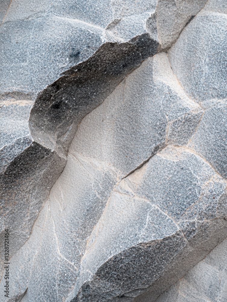 Poster close-up of a rock surface. the rock appears to be made up of different sizes and shapes, with some 