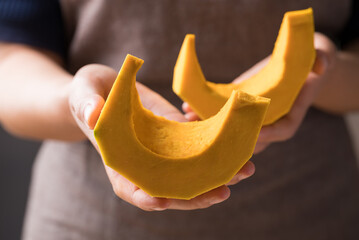 Section and peeled pumpkin holding by hand, Homemade cooking