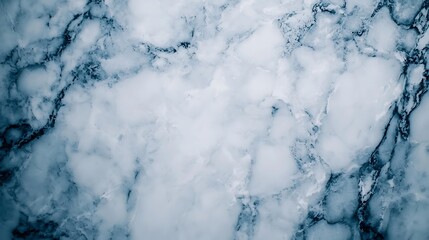 A close-up view of a textured marble surface featuring a blend of white and gray hues, showcasing its natural elegance and intricate veining patterns.