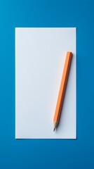 A blank sheet of paper lies on a blue background, accompanied by a vibrant orange pencil, suggesting creativity and potential for ideas.