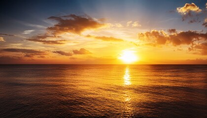 Obraz premium A breathtaking sunset over the ocean, with dramatic golden hues reflecting on the water, creating a peaceful and relaxing tropical escape.