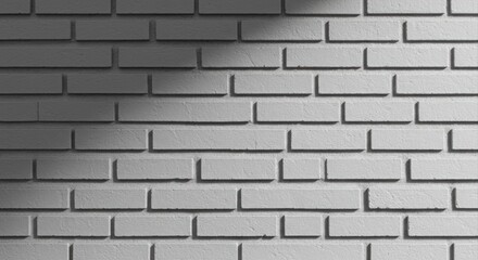 Fototapeta premium Light and shadow on a textured gray brick wall.