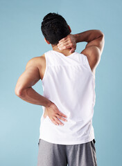 Back pain, injury and man in studio, inflammation and aching body on blue background. Person, model...