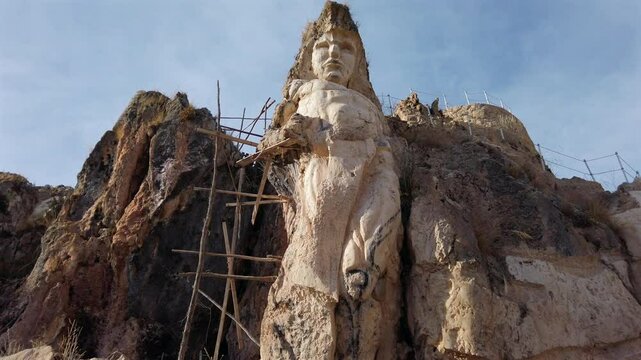 Close up view of Inca deity massive sculpture in white stone at Morada de los Dioses Apukunaq Tianan modern park near Cusco, Peru
