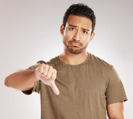 Portrait, sad and man with thumbs down in studio for fail, bad review and wrong on white...