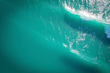 Turquoise ocean waves from above, a serene seascape of calm and beauty.