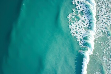 Turquoise ocean waves from above, a serene seascape of calm and beauty.