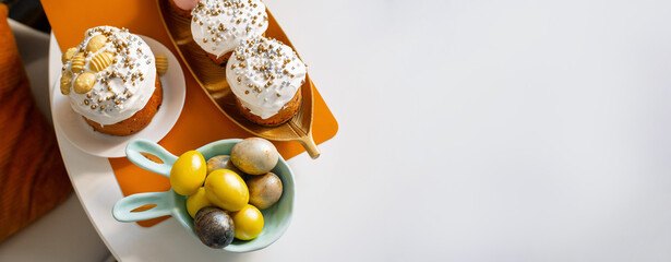 Top view of Easter eggs painted with yellow paint. White background. Copy space.