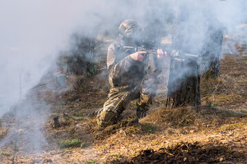 Soldiers in the forest. Military men in camouflage with weapons.