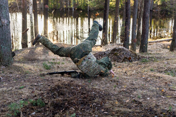 Soldiers in the forest. Military men in camouflage with weapons.