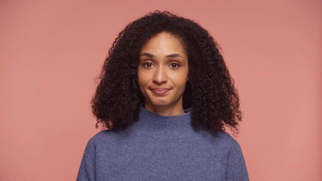 Woman Shrugging with Confused Expression on Pink Background