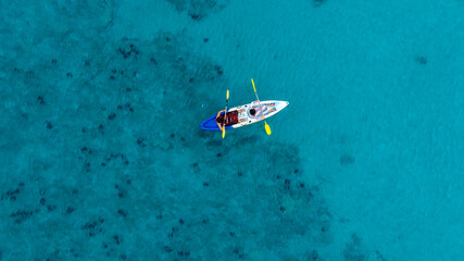Aerial view of a kayak in the blue sea .man kayaking he does water sports activities.	