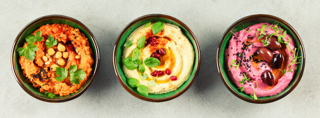 Trio of Colorful Hummus Variations in Rustic Bowls