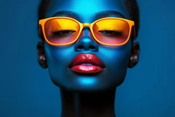 Vibrant portrait of woman with blue skin and orange glasses © MastersedZ
