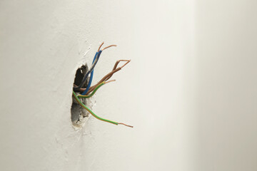 Electrical Outlet Repairing and Assembling - home improvement concepts. Master electrician installs a socket in the house. DIY home project.	