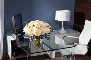 Elegant workspace with a bouquet of white roses