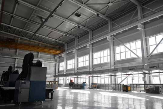 Yellow overhead traveling gantry crane beam on the pillars and truss ceilings of industrial building. Crane runway girder and metal structures. Interior of industrial storehouse or hangar