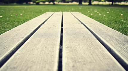 Wooden planks on grass in park, creating serene outdoor atmosphere