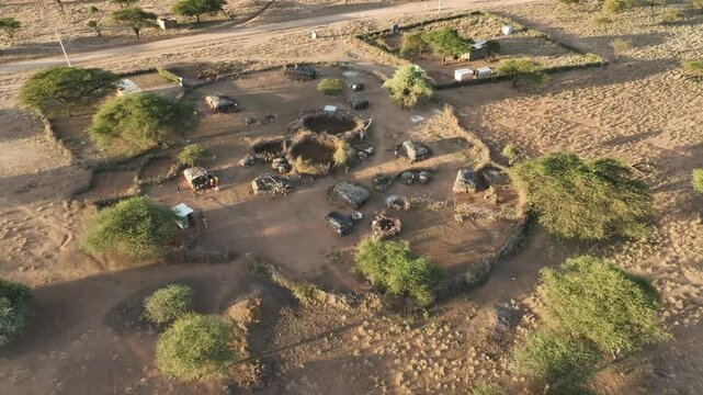 Aerial view of traditional manyatta village with huts and trees in a rural landscape, Wamba, Samburu, Kenya.