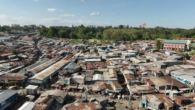 Aerial view of kibera slum with rooftops and greenery adjacent to royal nairobi golf club, nairobi, kenya.