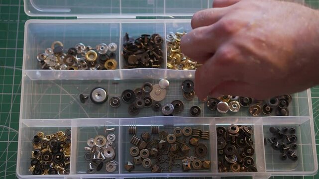 The master leatherworker is looking for the necessary item in the organizer