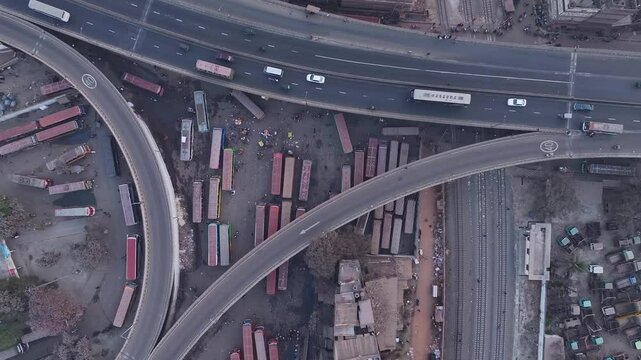 Aerial view of busy bus terminal and highway with traffic and modern infrastructure, Dhaka, Dhaka, Bangladesh.