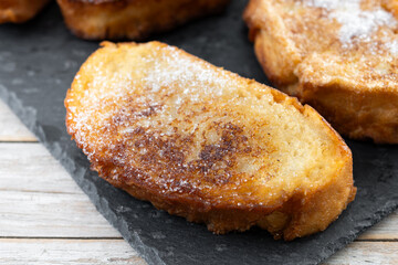 Traditional Spanish torrijas for Holy Week on wooden table. French Toast