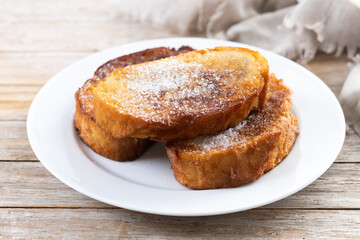 Traditional Spanish torrijas for Holy Week on wooden table. French Toast