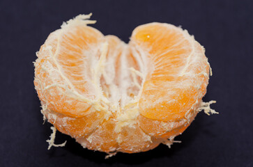Macro Shot of a Partially Peeled Mandarin background 