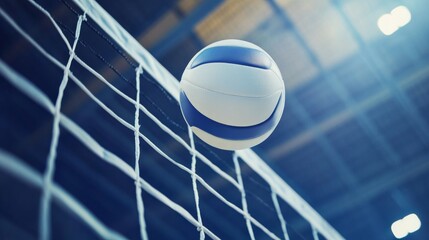 Low-angle close-up of a white leather volleyball soaring over the net in an indoor volleyball arena during a competitive match, capturing the fast-paced action and intensity of the game.



