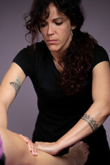 chiropractor exerting pressure on patient's leg