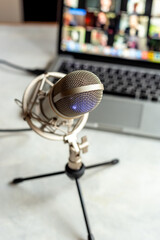 Podcast recording - laptop computer and microphone on the table, close up