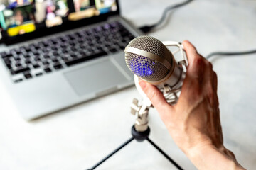 Home studio for podcast recording. Microphone and laptop on table