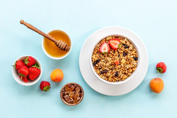 Breakfast with cereal granola honey and strawberry, top view
