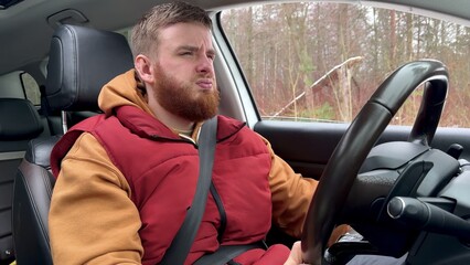 male driver buckled up in car and feels bad. depressed, lost