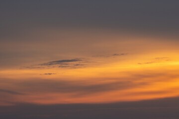 An orange and beautiful sky with a stunning cloudscape at dusk, just before sunrise. The wonderful...