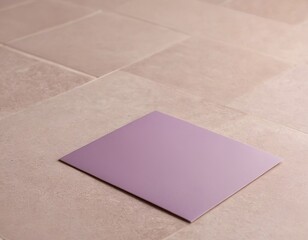Fototapeta premium A solitary purple sheet positioned on a light tiled floor, creating a calm and minimalist vibe.