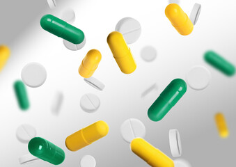 Many different pills flying on grey gradient background