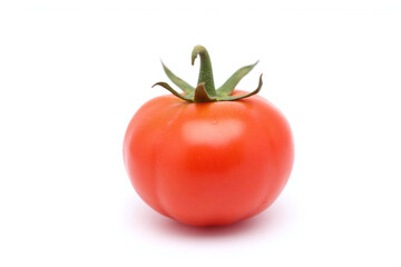 single tomato on white surface with water droplets