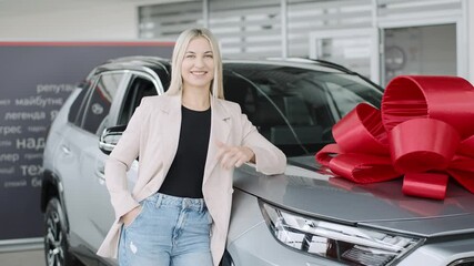 Excitement in a car showroom with a woman showcasing a vehicle and celebrating success