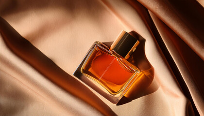 Top View of Elegant Blank Perfume Bottle Mockup with Amber Liquid in a Warm Temperature. Perfume with Silk Fabric Background and Natural Daylight.