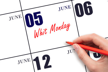 June 5. Hand writing text Whit Monday on calendar date. Save the date.