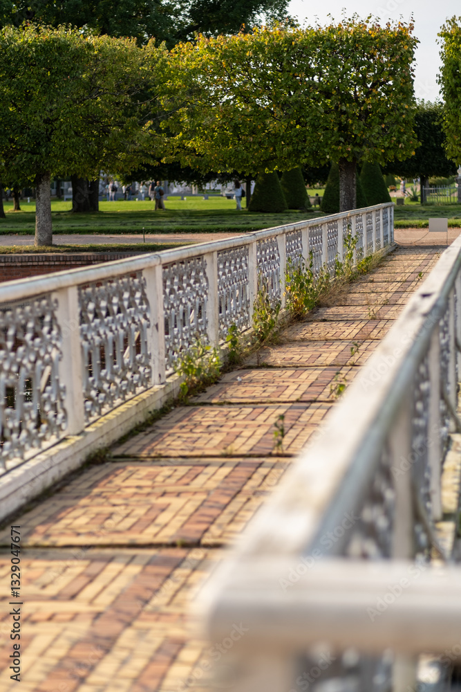 Leinwandbilder exploring the serene pathways of peterhof with lush greenery and intricate ironwork details during a