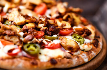 Gyros Pizza with jalapeno pepper, cherry tomatoes and mozzarella cheese. Soft focus. Close up.