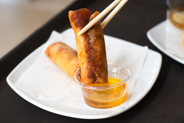 Deep fried Chinese Chives Spring Rolls on a white plate.